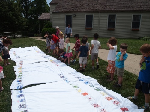 The 3-6 year olds find their pieces of the rainbow in spite of the very sunny skies. 